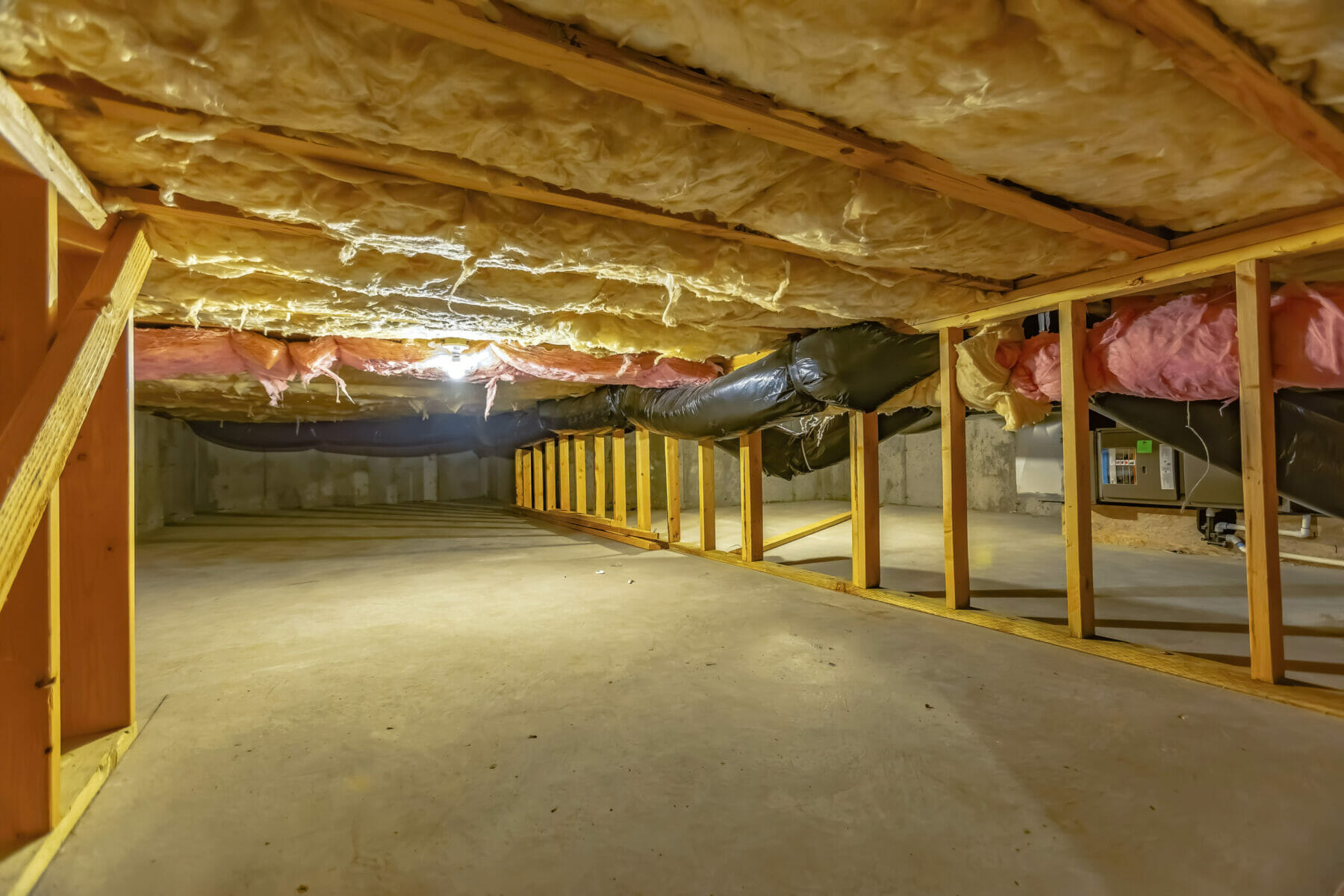 crawl space with upper floor insulation and wooden support beams